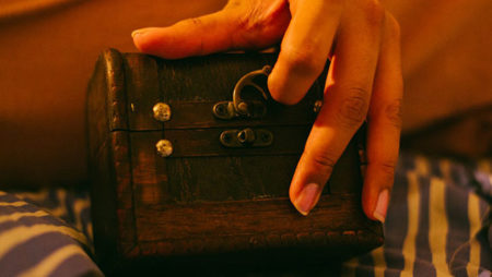 small box with latch being opened by womans hand