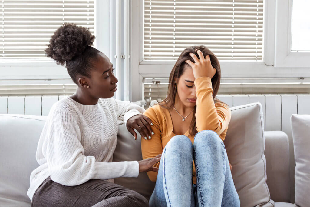 Female friends supporting each other through grief