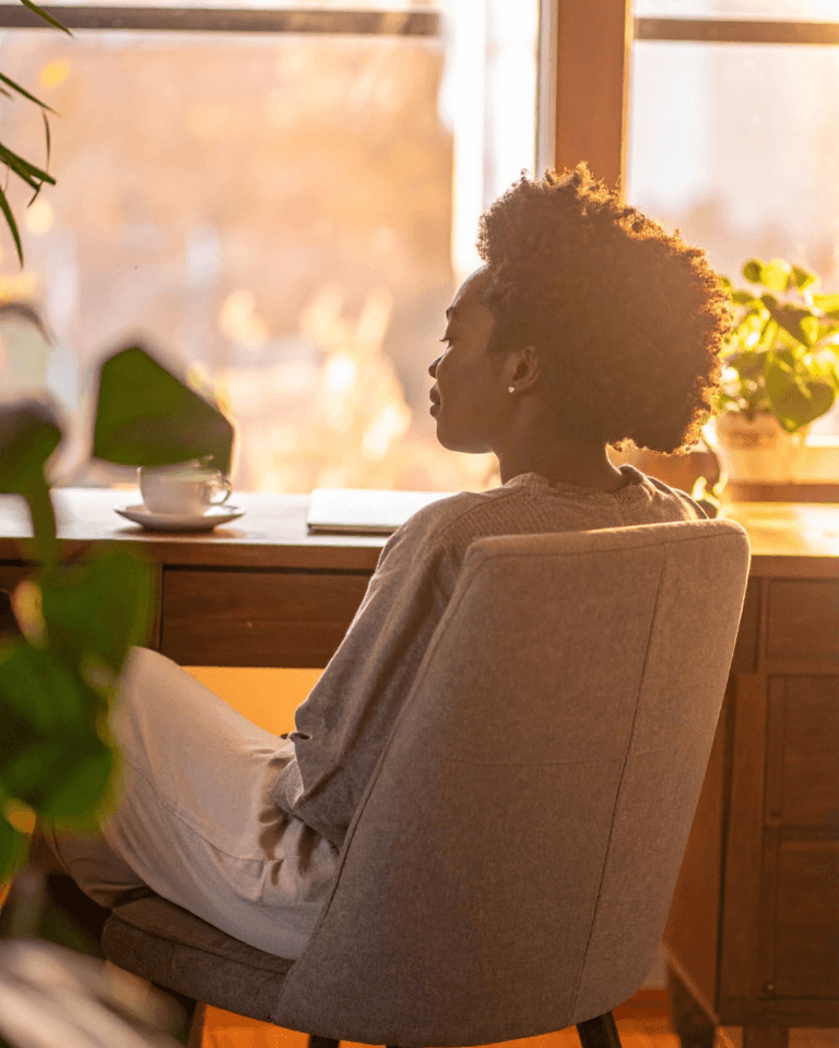 Woman sitting quietly, reflecting on patterns she can't change
